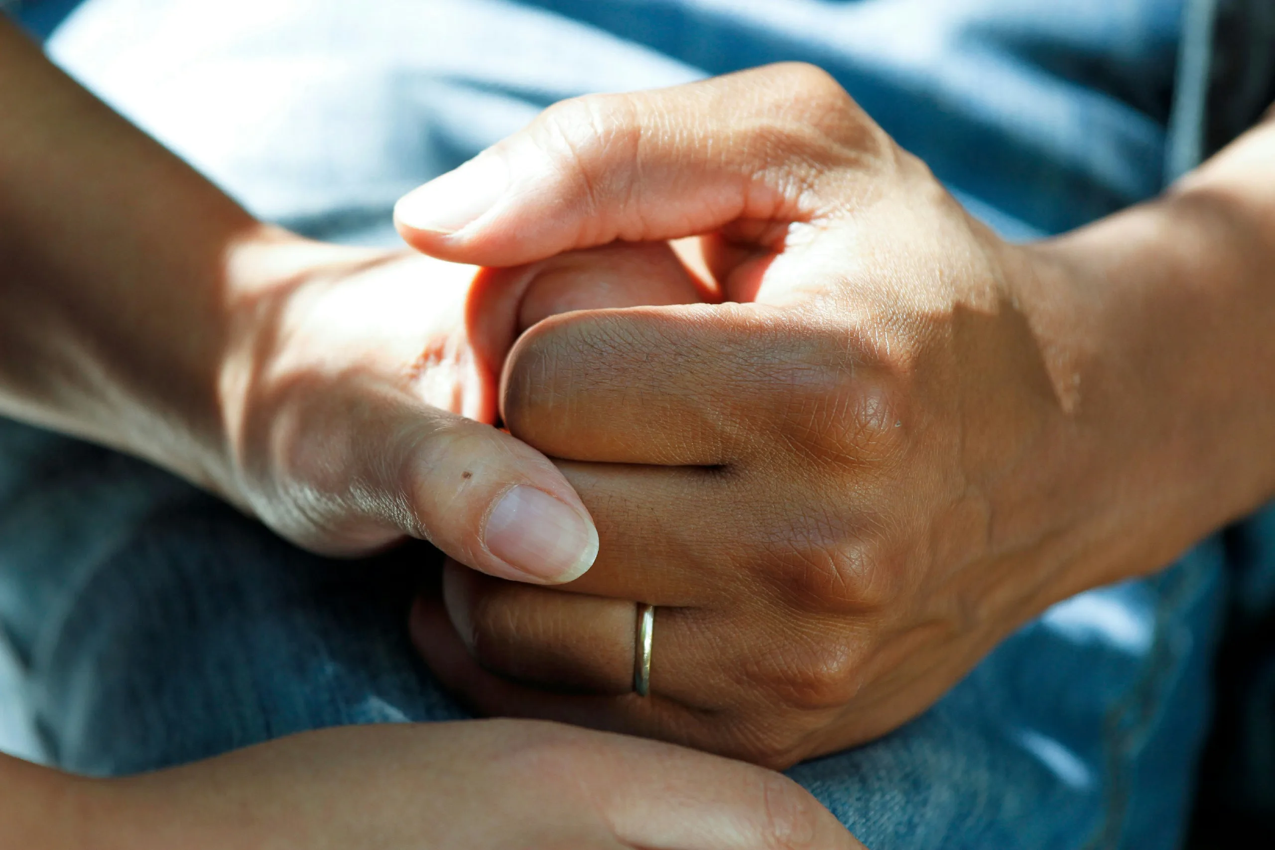 decorative image of two hands clasped, to accompany blog post on financial planning for carers