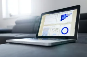decorative image to accompany blog post on cashflow planning. Open laptop with charts showing on the screen.