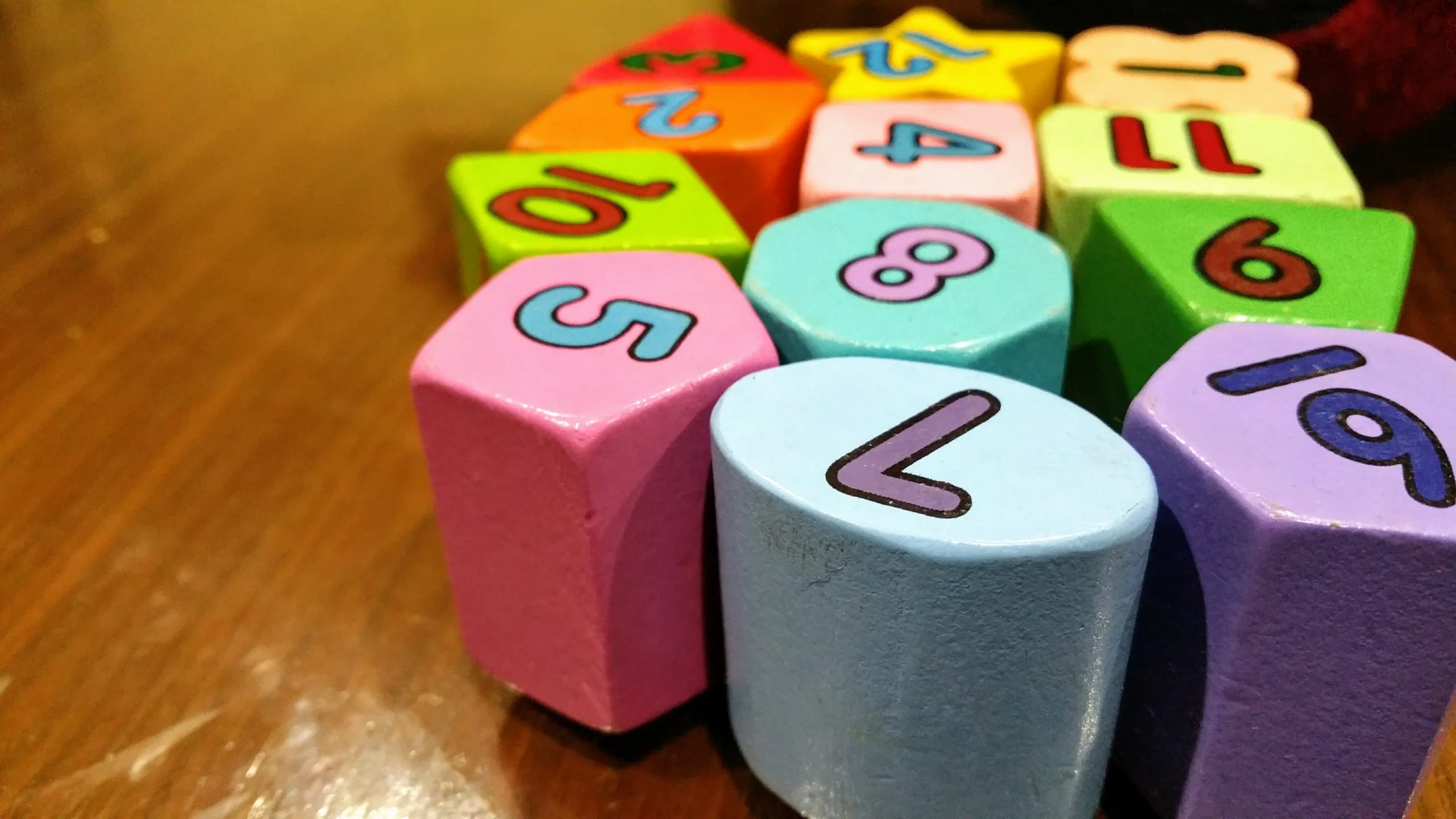 decorative image to accompany blog post on selling your business. coloured childrens toy blocks with numbers on, sitting on a wooden table top
